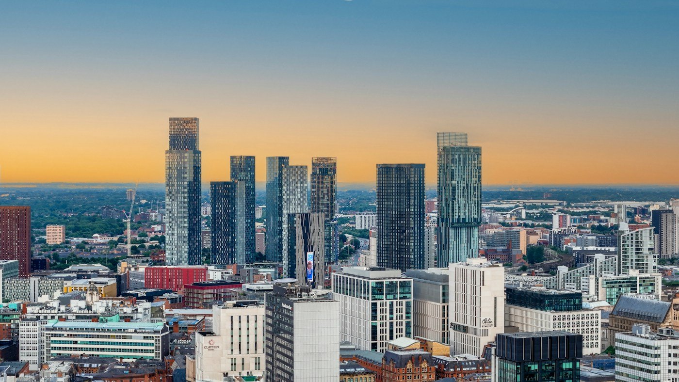 Manchester’s modern skyline beneath a golden evening sky