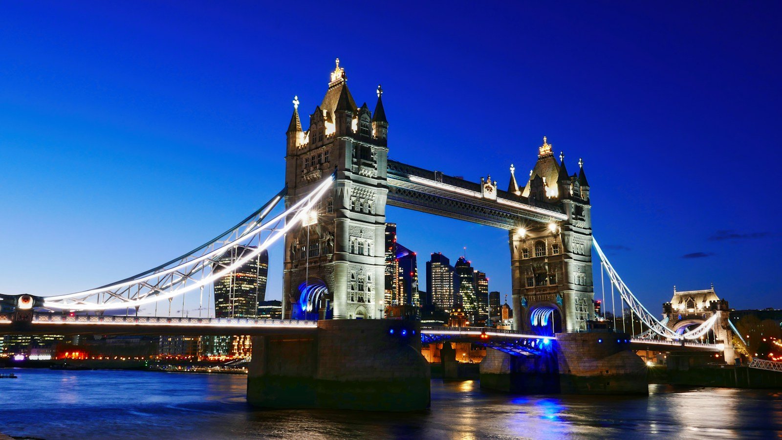 London’s illuminated Tower Bridge above the River Thames at blue hour